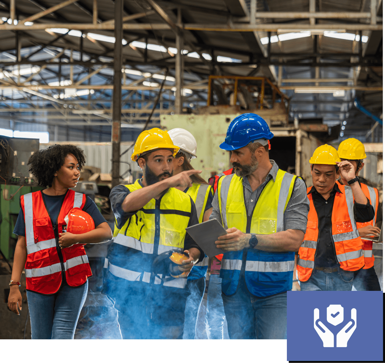 Workers discussing in an industrial factory setting.