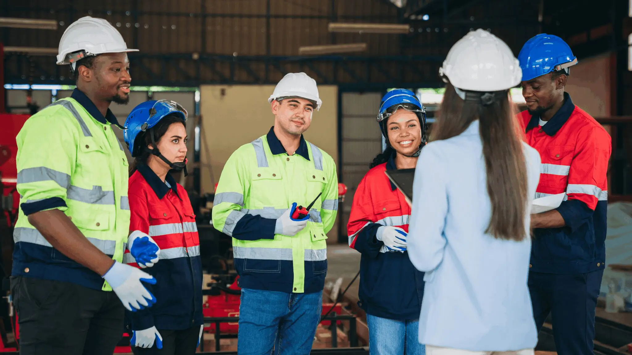 Workers in safety gear having a meeting.