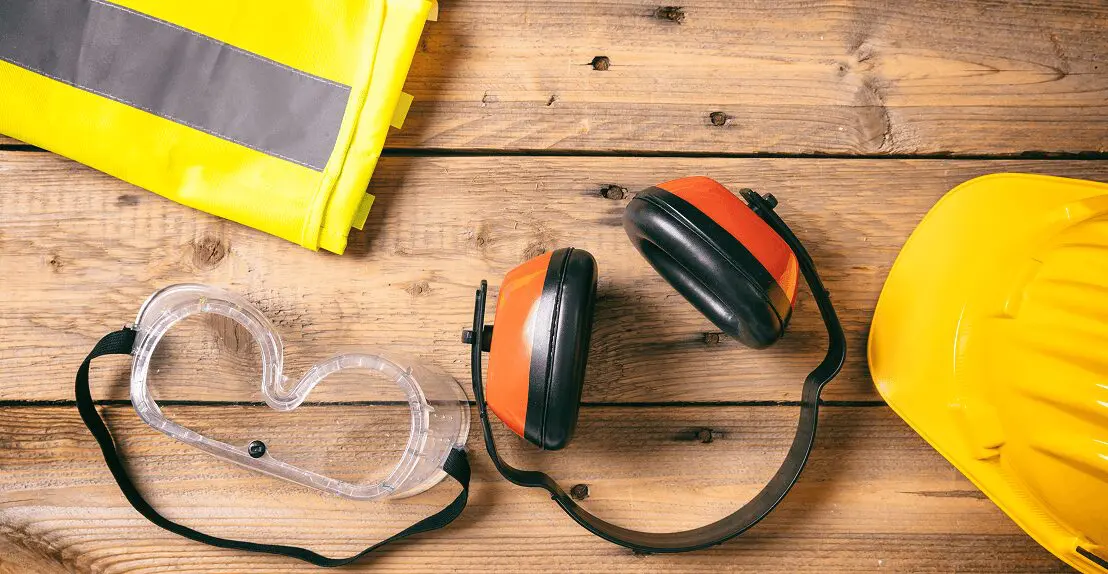 Safety gear on wooden surface.